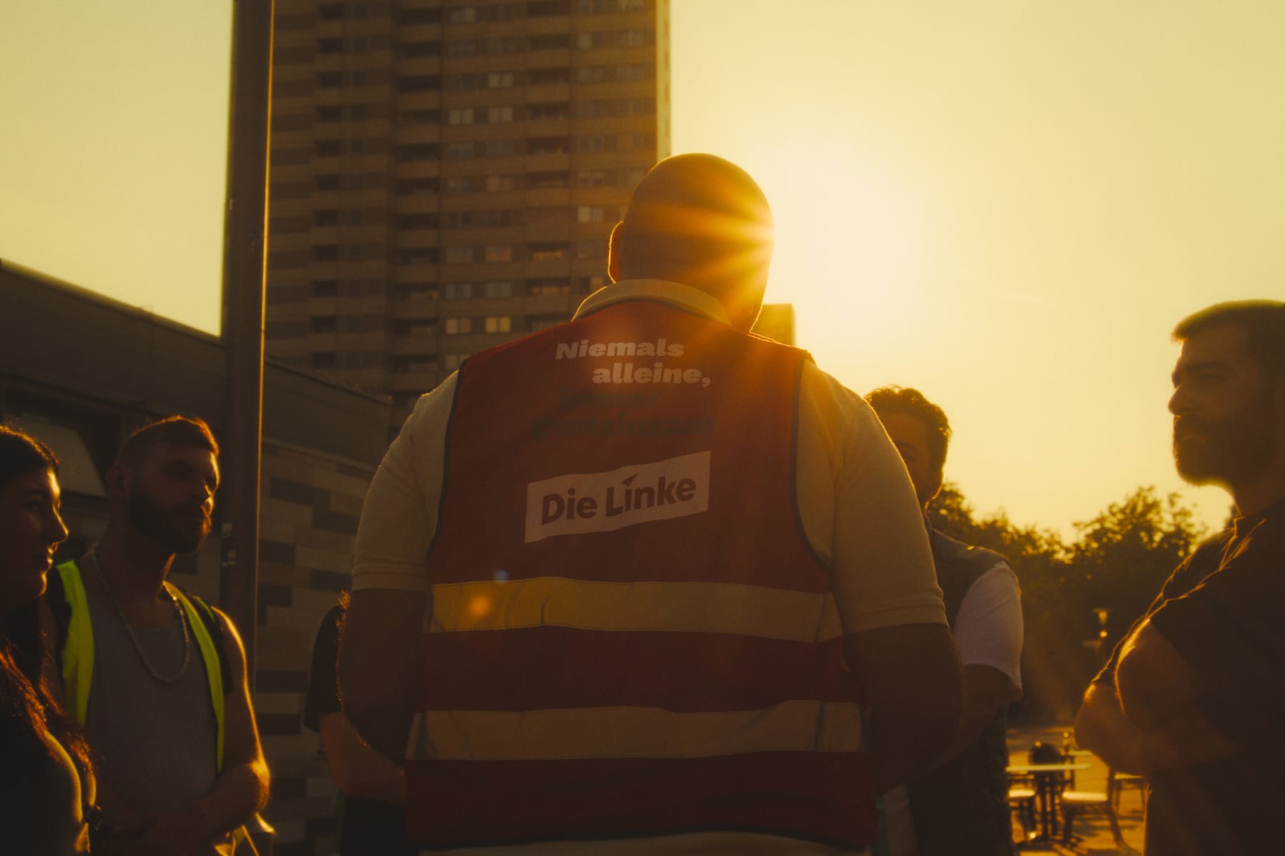 Das Team im Abendlicht vor einem Hochhaus der Gropiusstadt